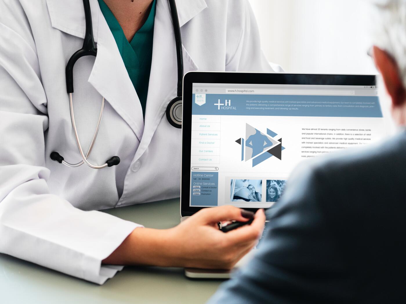 Doctor showing person a laptop screen