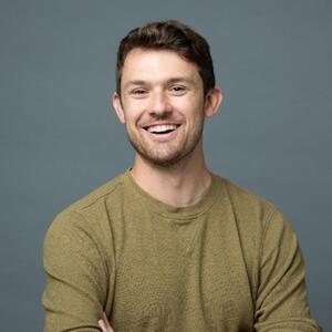 Headshot of a man with a crew neck shirt.